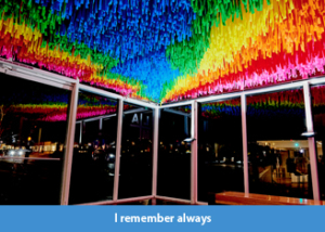 A rainbow-hued, large-scale installation at the Laguna Art Museum in Laguna Beach, California that is suspended from the ceiling, comprised of colorful flagging tape.